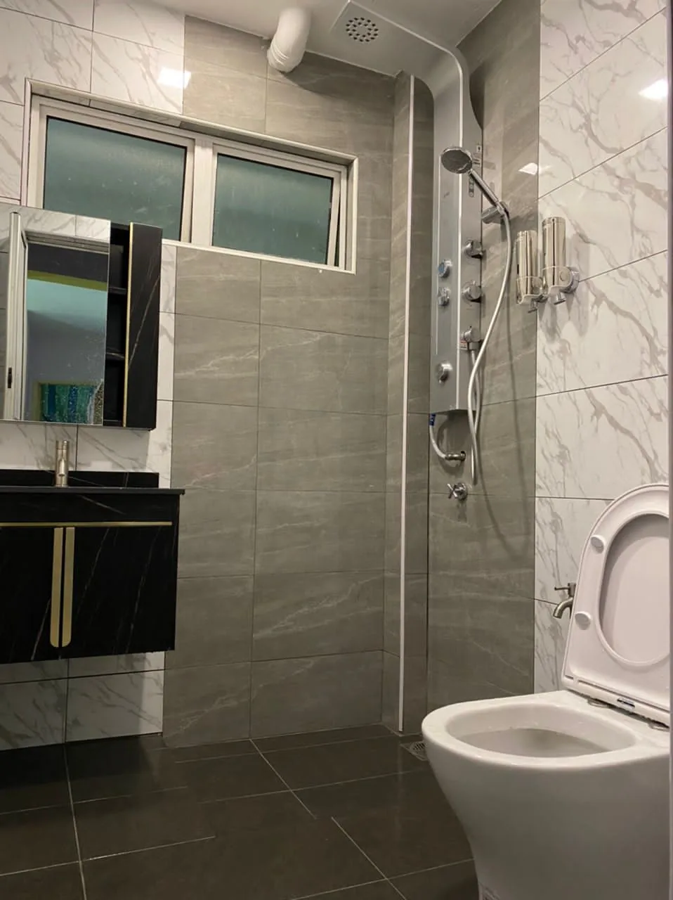 After: refurbished bathroom with marble-look tiles